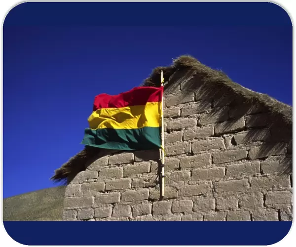 San Antonio, Bolivia, Bolivian flag waving from a mud brick hut in the High Altiplano