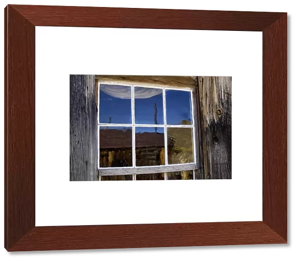 USA, California, Bodie State Historic Park, Ghost town building reflected in window