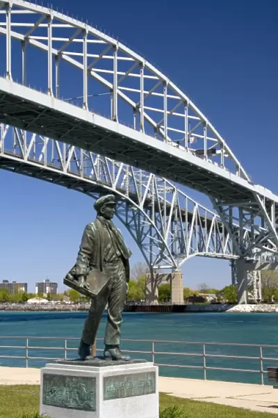 A statue of Thomas Edison by local artist Mino Duffy sits below the Blue Water Bridge along the St