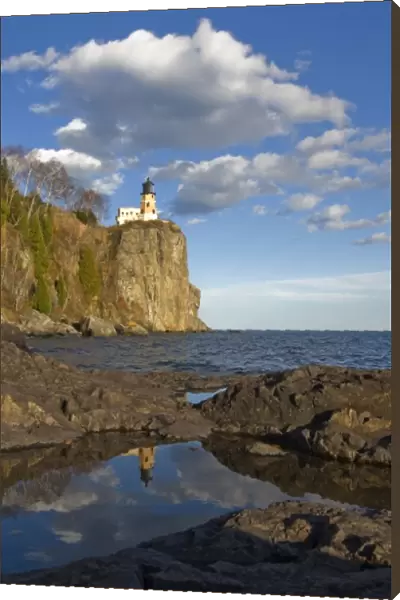 USA, Minnesota. Split Rock Lighthouse reflects in a pool on the shore of Lake Superior