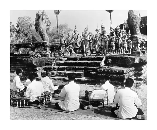 Traditional dancers and musicians performing at the ruins at Angkor, Cambodia. Photographed c1960