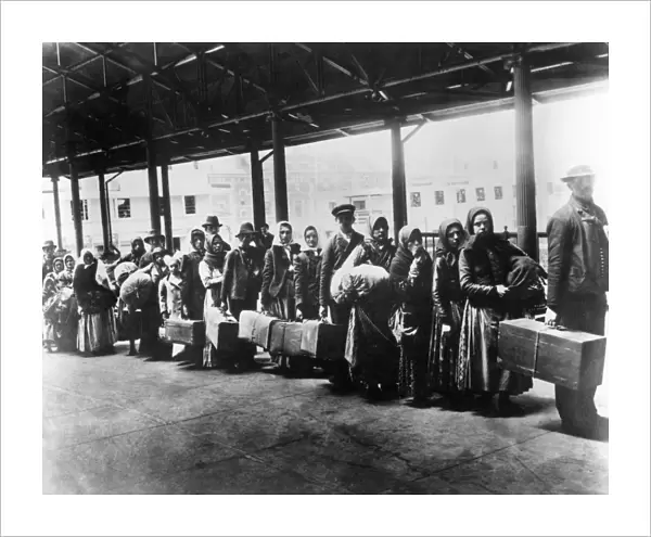 IMMIGRANTS: ELLIS ISLAND. Immigrants arriving at Ellis Island, c1900