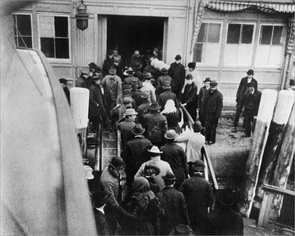NEW YORK: BATTERY, 1902. Immigrants disembarking from the ferry boat from Ellis