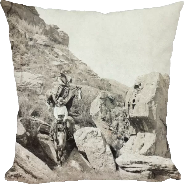 TEXAS: COWBOYS, c1908. Two cowboys on horseback traveling down a rocky hillside