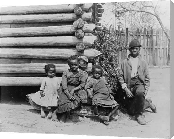 GEORGIA: CHILDREN, c1886. A group of African American children outside a log building