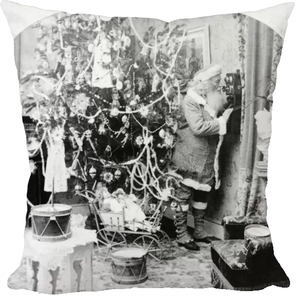 CHRISTMAS EVE, c1897. A studio photograph of Santa Claus speaking on a telephone