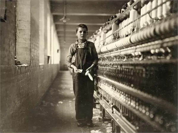 HINE: CHILD LABOR, 1911. A bobbin boy in the spinning room of a textile mill in Chicopee