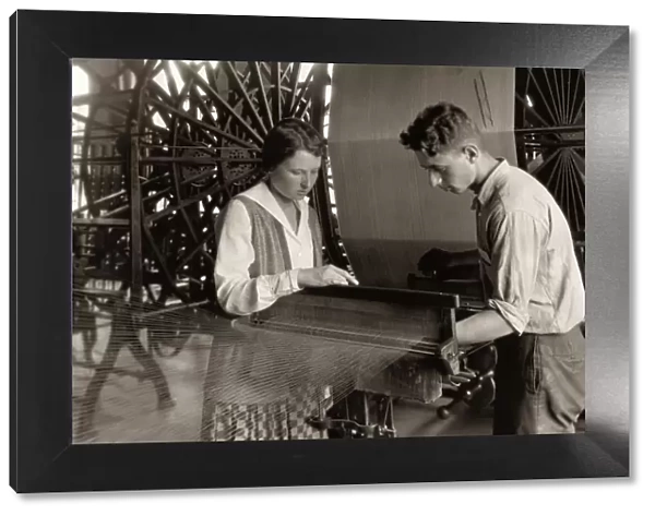 HINE: SILK MILL, 1924. A boy and a girl working a loom at the Cheney Silk Mills