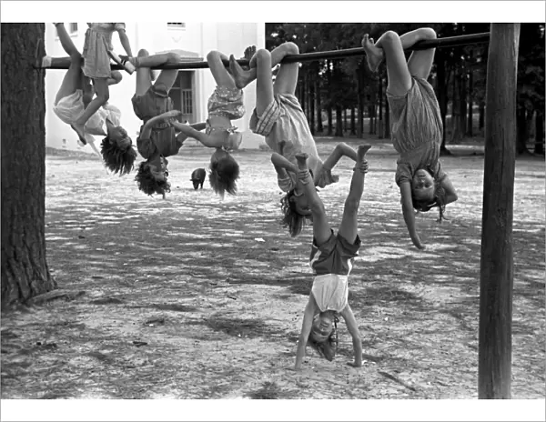 GEORGIA: PLAYGROUND, 1938. A group of schoolgirls hanging upside down in a playground