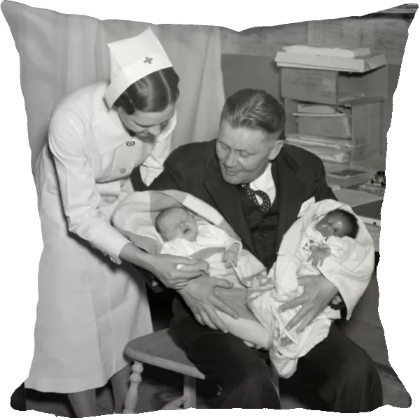 RED CROSS: FLOOD, 1937. A Red Cross nurse and man with two babies born at Tent City
