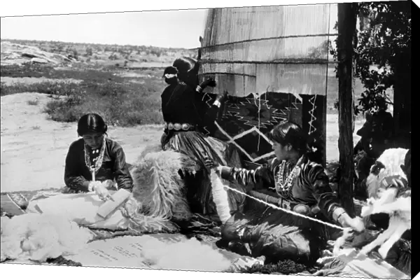 NAVAJO WOMEN WEAVING. Three Navajo women combing wool, spinning thread and weaving a blanket