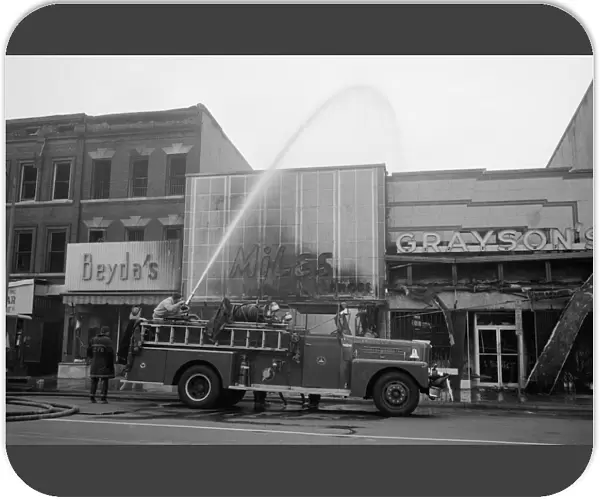 WASHINGTON: RIOTS, 1968. Firemen hosing down buildings that were burned during