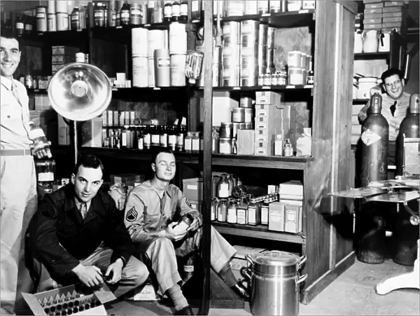MELBOURNE: US ARMY HOSPITAL, 1943. Soldiers in the pharmacy supply room of a U. S
