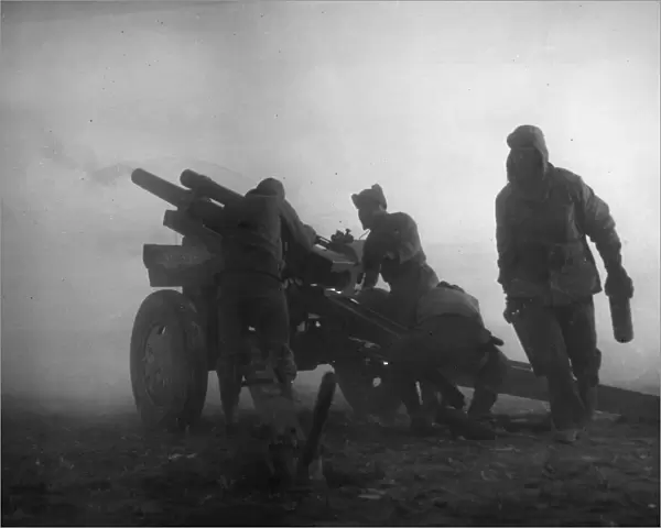 KOREAN WAR: ARTILLERY. U. S. Marine artillerymen firing in the fog on a North Korean concentration on the fighting front, early March 1951