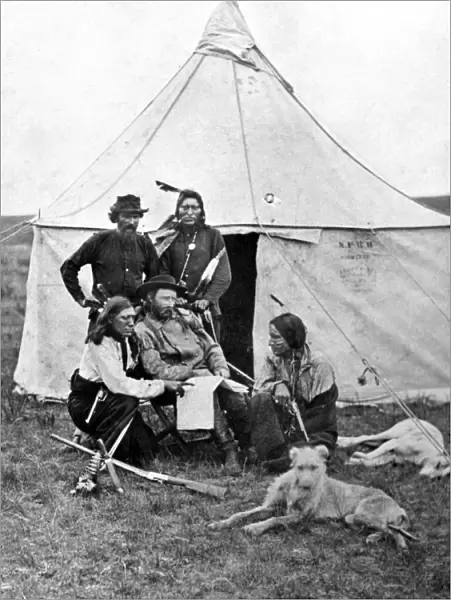 GEORGE ARMSTRONG CUSTER (1839-1876). American army officer. Photographed with scouts during the Yellowstone Expedition, 1873
