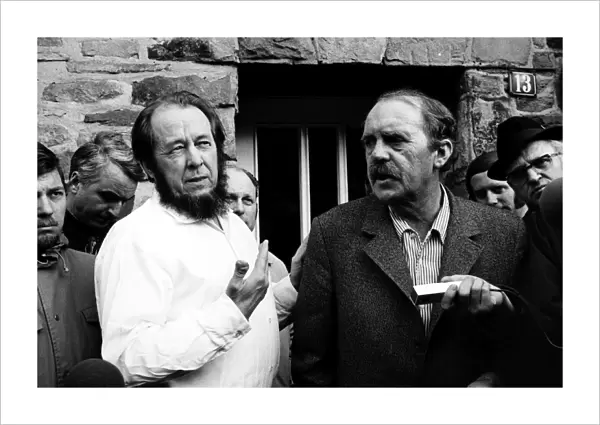 SOLZHENITSYN AND B├ûLL, 1974. Russian writer Alexander Solzehnitsyn (left) and German writer Heinrich B├Âll photographed outside B├Âlls residence in Langenbroich, West Germany, February 1974, following Solzhenitsyns exile from the Soviet Union