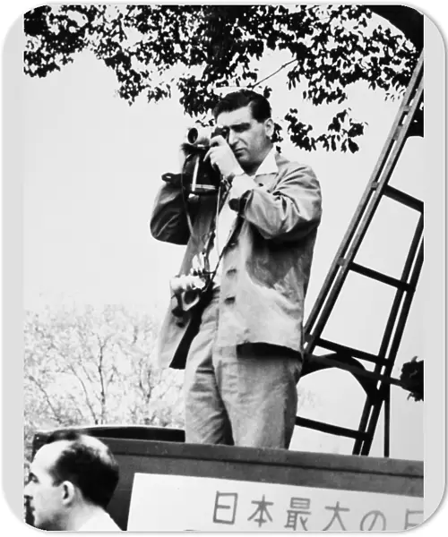 ROBERT CAPA (1913-1954). Hungarian-born American war photographer. Capa photographing a May Day demonstration in Tokyo, 1954