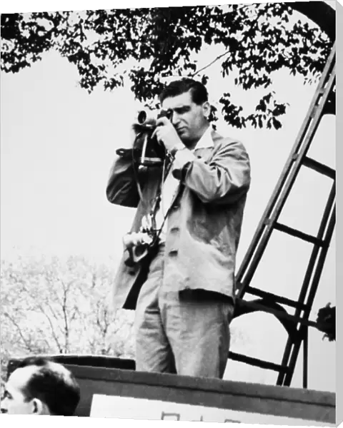 ROBERT CAPA (1913-1954). Hungarian-born American war photographer. Capa photographing a May Day demonstration in Tokyo, 1954