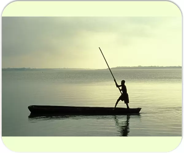 Boy rowing on Lake Togo, Aneho, Togo