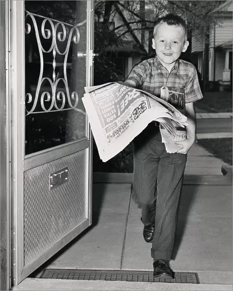 portrait of a boy distributing newspapers