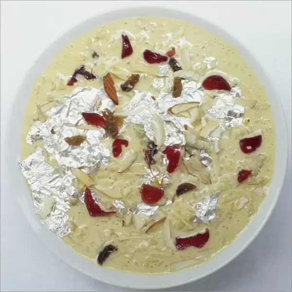 Kheer, Indian pudding made of rice and milk, elaborately garnished with candied fruits and sheets of beaten silver
