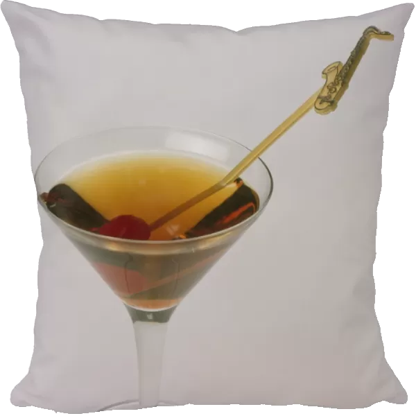 Manhattan cocktail in martini glass with cocktail cherry and stirrer