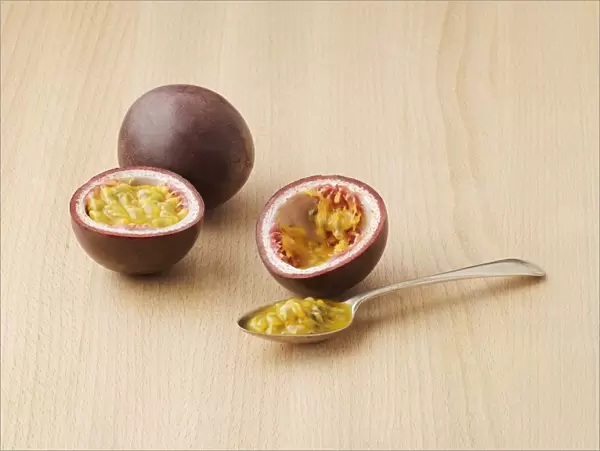 Passionfruit, cut in half, and on spoon
