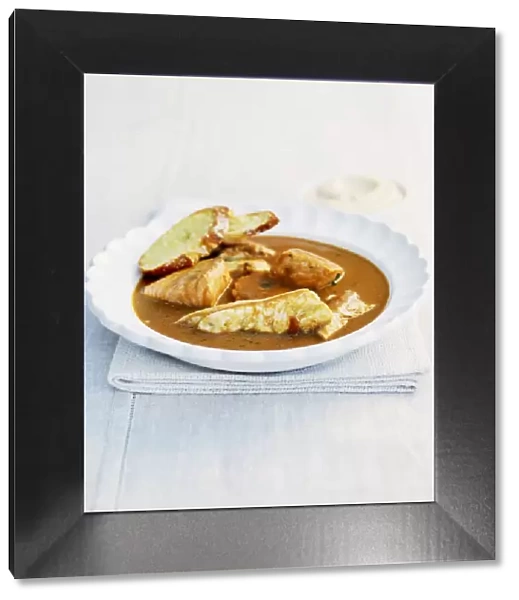 Bowl of Bouillabaisse fish stew with baguette slices
