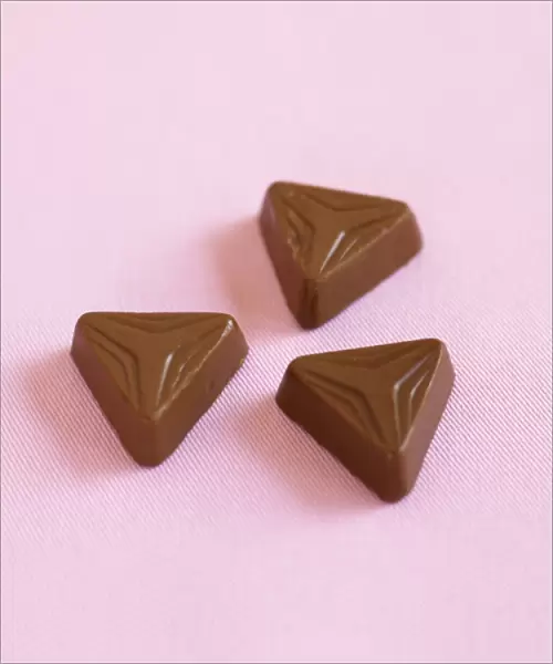 Three triangular shaped chocolates