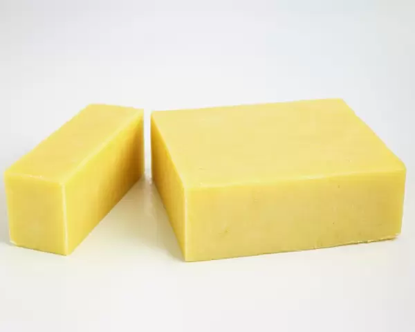 Sliced block of New Zealand cheddar cows milk cheese