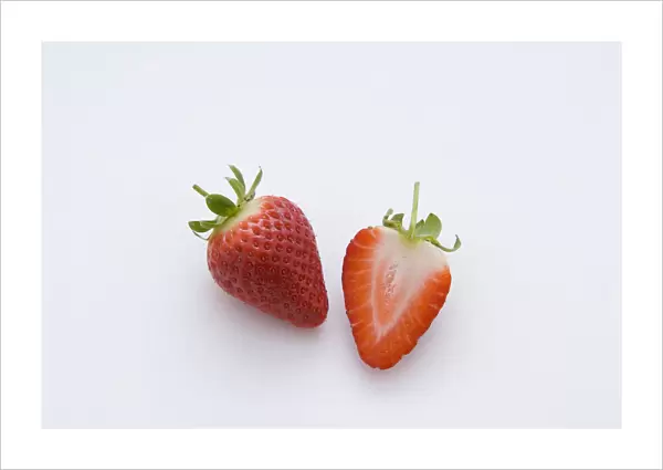 One strawberry and half strawberry, close-up