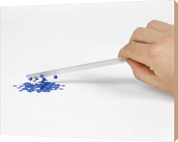 Picking up pieces of paper with electrically charged plastic ruler