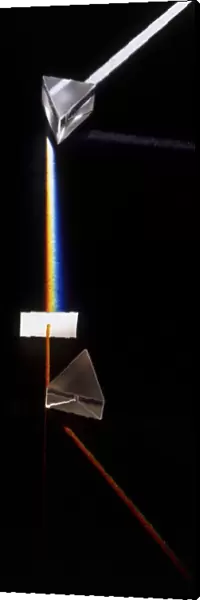 Prism splitting white light ray into colours of the visible spectrum, side view