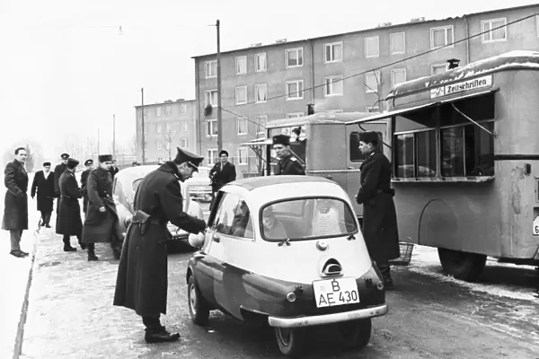 The first west berliners crossing over at the sonnenallee checkpoint to visit relatives in east berlin in accordance with a recently signed treaty allowing such visits, december 1963