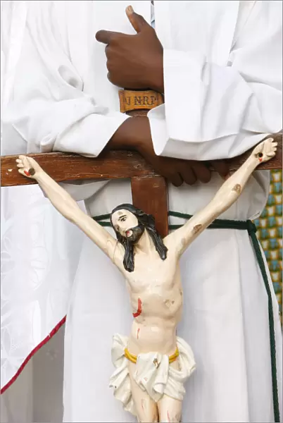 Altar boy holding a crucifix