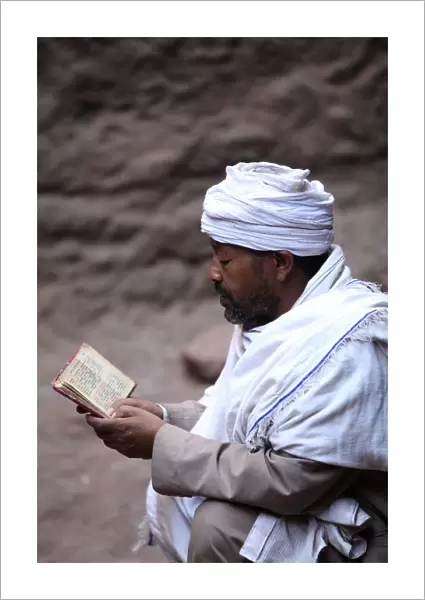 Man reading scriptures outside a Lalibela church
