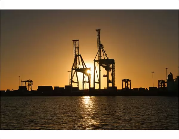 Port Cranes Against Sunset