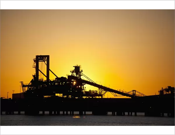 Silhouette of a bucket wheel reclaimer at an iron ore mine