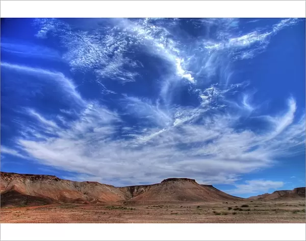Wispy clouds over desert