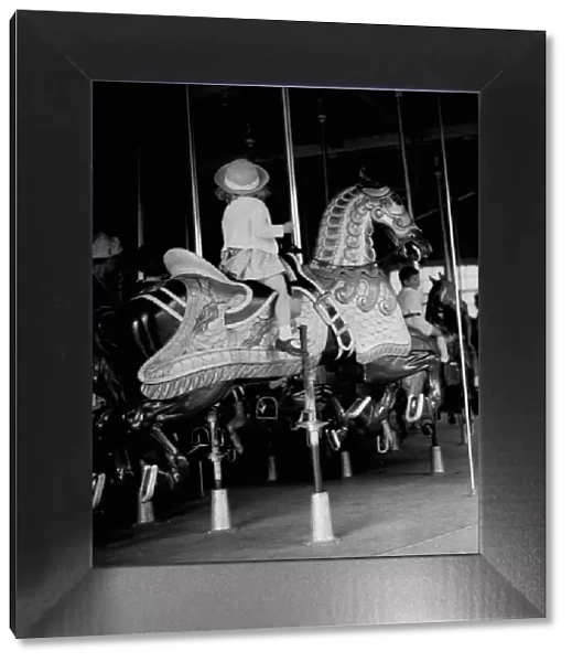 Girl riding a carousel