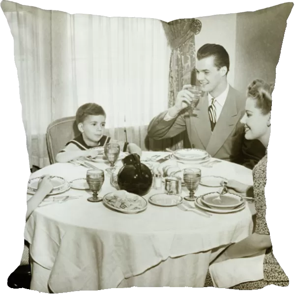 Family sitting around table, having meal, children (4-5) (6-7), (B&W)