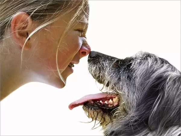 Girl and dog sniffing each others noses