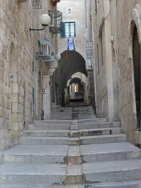 Deserted alleyway with Israeli flag hanging from a window above an archway, Muslim Quarter, Old City, Jerusalem, Middle East