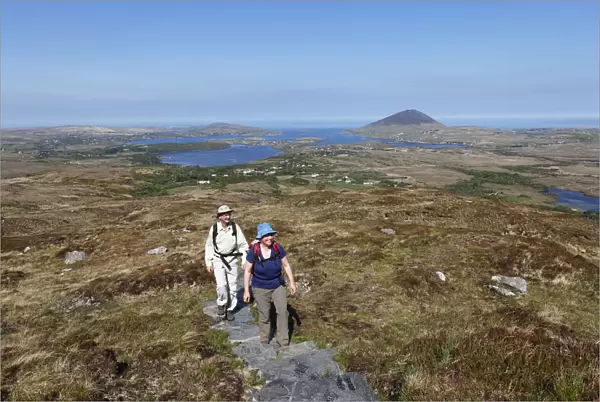 Hikers climbing to Diamond Hill, Connemara National Park, County Galway, Republic of Ireland, Europe
