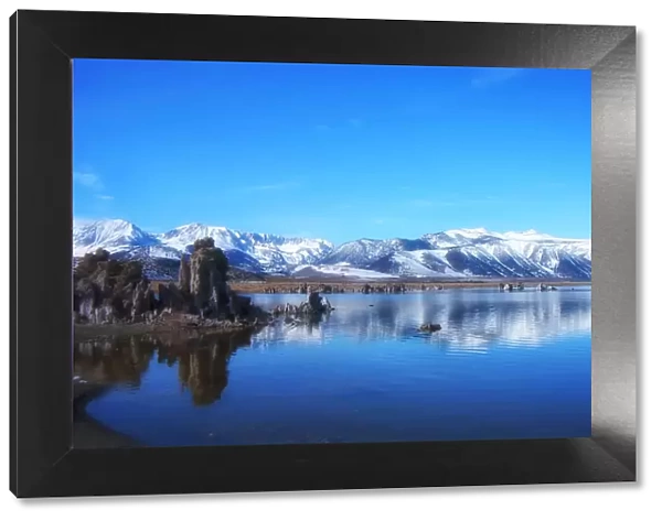 Mono lake. Clear sky over snow covering mountains with reflection on Mono lake in winter