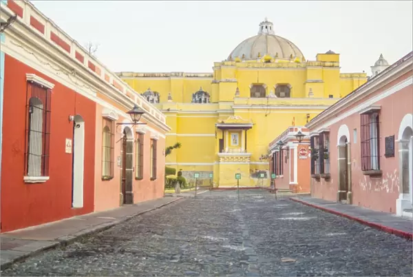 Multicolored street of Antigua, La Merced Church on background