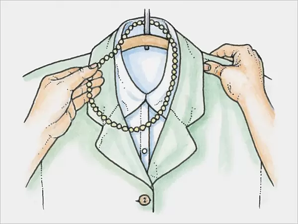 Hands placing necklace of beads over hanger holding jacket and blouse