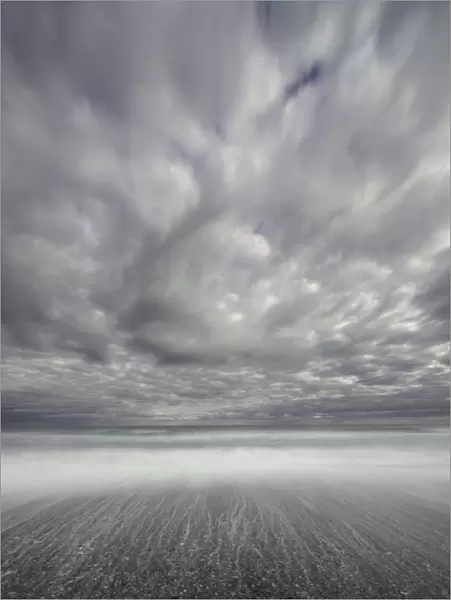 Dramatic clouds above sea and beach, New Zealand