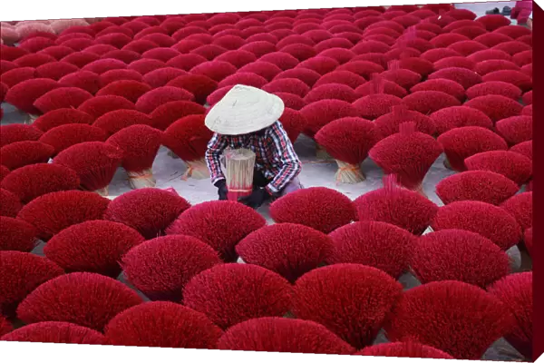 Vietnam - woman making red insense