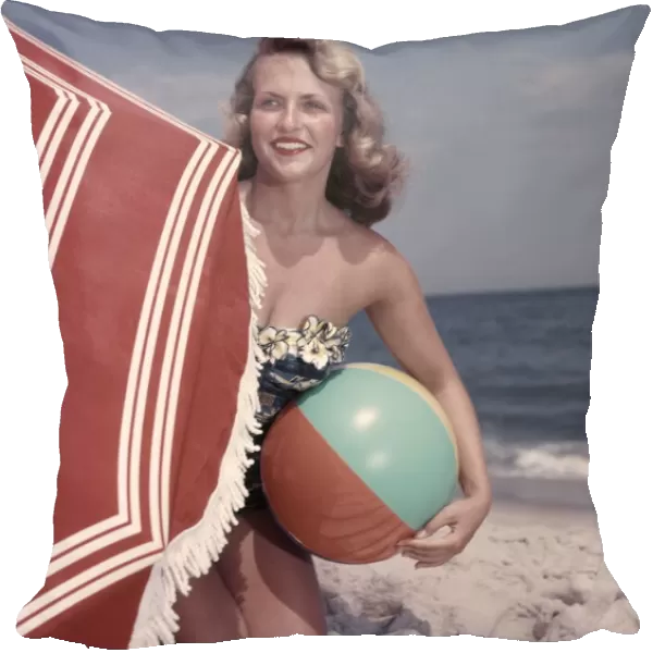 Smiling Blonde Woman Bathing Suit Hold Beach Ball Kneel In Sand By Red Sun Umbrella